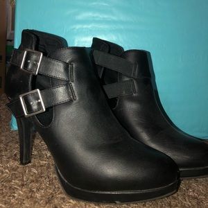 Black heeled ankle boots with buckled on the side